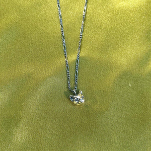 Hellhound jewelry necklace, Hellhound jewelry goth, alt jewelry, alternative jewelry, cat jewelry, cathead necklace, cat head charm necklace, charm jewelry on a green fabric background
