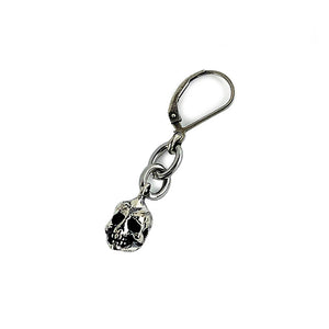 A Silver skull and chain dangle earring by Hellhound Jewelry.