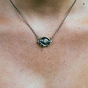 Sterling silver opal evil eye necklace, opal necklace, sterling silver necklace, hellhound jewelry necklace, model wearing opal evil eye necklace, faceted opal necklace, gemstone necklace, gemstone jewelry, gemstone