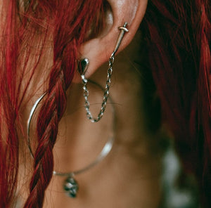 Dagger and heart double stud with chain, dagger earring, heart earring, chain earring, sterling silver earring, hellhound jewelry earring, double stud stabby earring on model