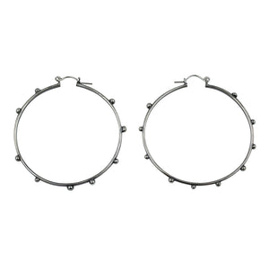 A product shot of studded silver hoop earrings. Hellhound jewelry hoop earrings.Sterling silver studded hoops, sterling silver earrings, hellhound jewelry earrings, hoop earrings