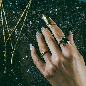 mother night collab ring, hellhound jewelry ring, flame ring, nail ring, claw ring, gold ring, fire claw ring on hand model with other hellhound jewelry