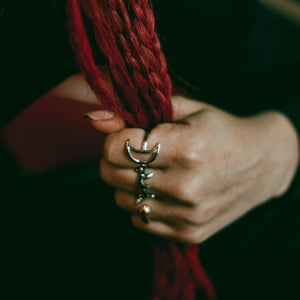 Luna ring, open moon ring, hellhound jewelry ring, moon ring, sterling silver ring, moon ring on model holding red braids